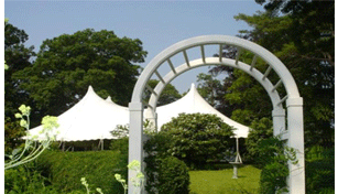 White garden arch and tents on the lawn